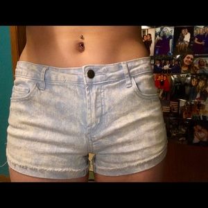 Light-wash acid-washed denim shorts.